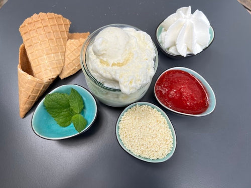 Die verschiedenen Zutaten, die man für ein Spaghetti-Eis braucht: Vanilleeis, Sahne, Erdbeersoße und weiße Schokoladenraspeln; Spaghettieisrezept nach Katchi Ice Cream