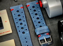 A close-up shot of a blue vintage rallye and racing watch strap, featuring a perforated leather design and white stitching. This unique and stylish watch strap is perfect for sports watches, chronographs, and racing-inspired timepieces. Check out our blog post to learn more about the benefits of rallye straps and how to choose the perfect one for your timepiece.