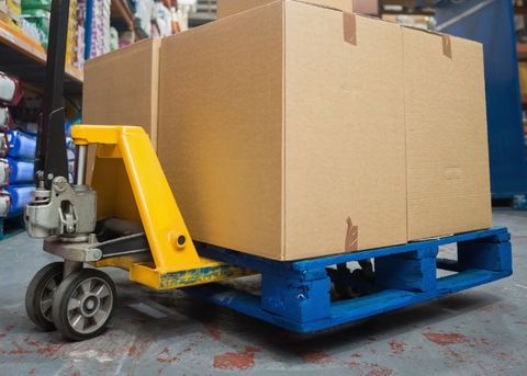 A castor wheel on a pallet with boxes on. 