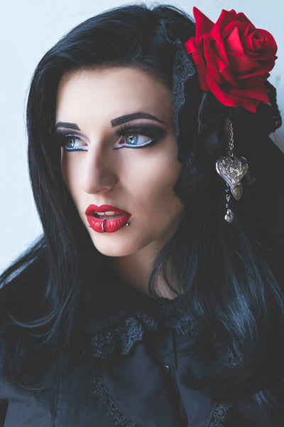 ivana hyde wearing a black and red rose hair corsage made by 8th sin, featured in femme rebelle magazine, photographed by busha bailey