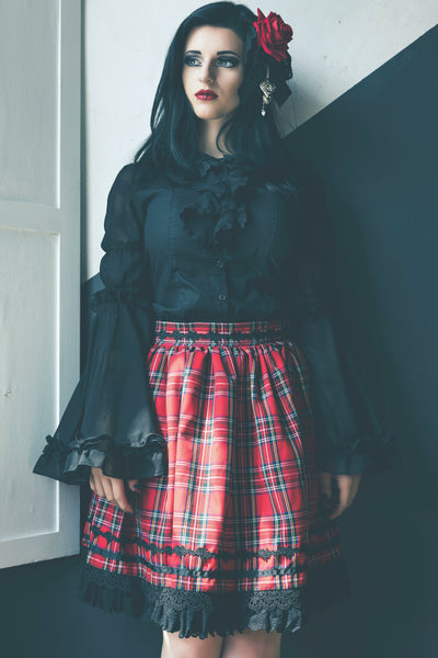 ivana hyde wearing a custom 8th sin skirt made using red stewart tartan fabric in a gothic lolita fashion style, featured in femme rebelle magazine, photographed by busha bailey
