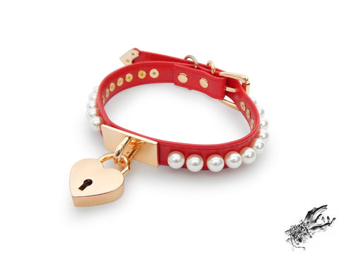 red and gold choker made of vegan leather, with a gold heart padlock in the centre and white pearl studs around either side