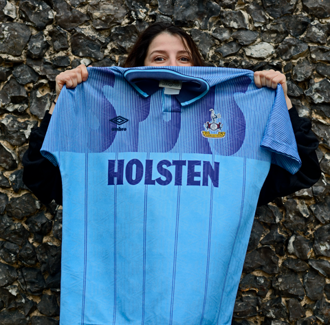 Girl holding up football shirt image - Tottenham Hotspur