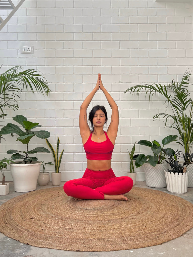 women doing yoga wearing red co-ord set