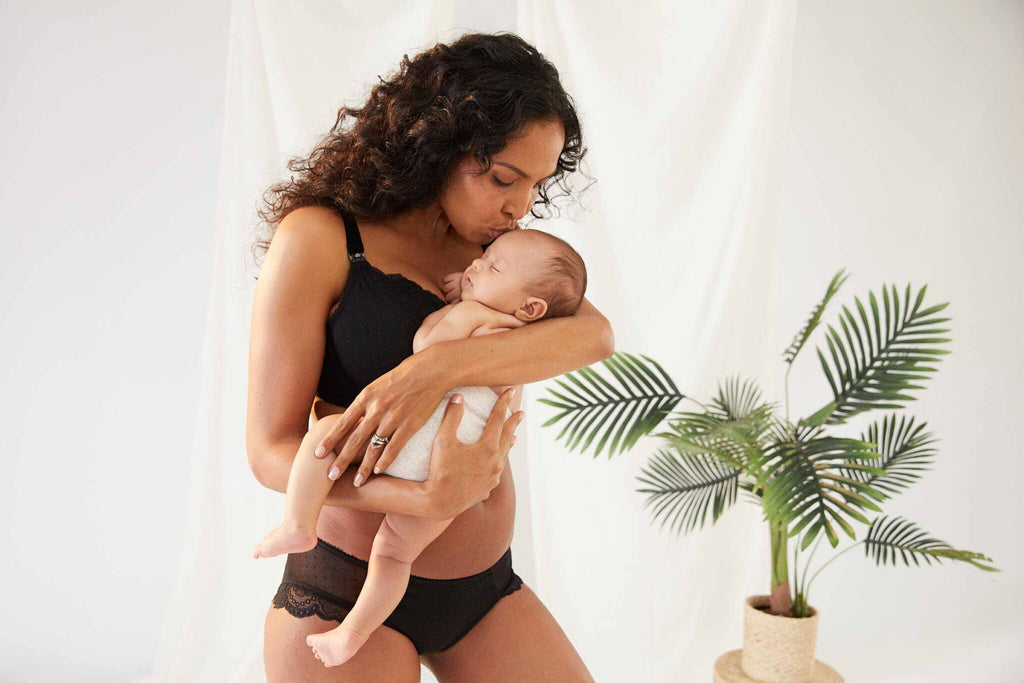 mother kissing baby