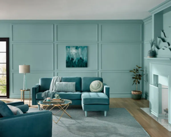 a cool blue room with paneled blue walls and tonally matched furniture