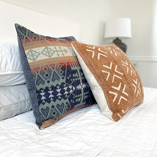 Handmade decorative pillows on a bed