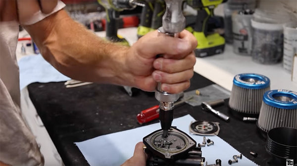 impact screwdriver being used to remove carburetor plate