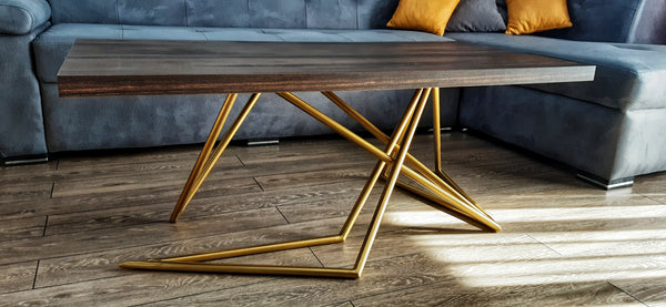 Step into the future of interior design with this avant-garde coffee table. Its golden metal base is a handcrafted marvel, engineered to offer both stability and a bold aesthetic statement. The striking metallic finish contrasts beautifully with the dark wooden top, creating an opulent centerpiece for your living area that is as much a piece of modern art as it is a functional table.