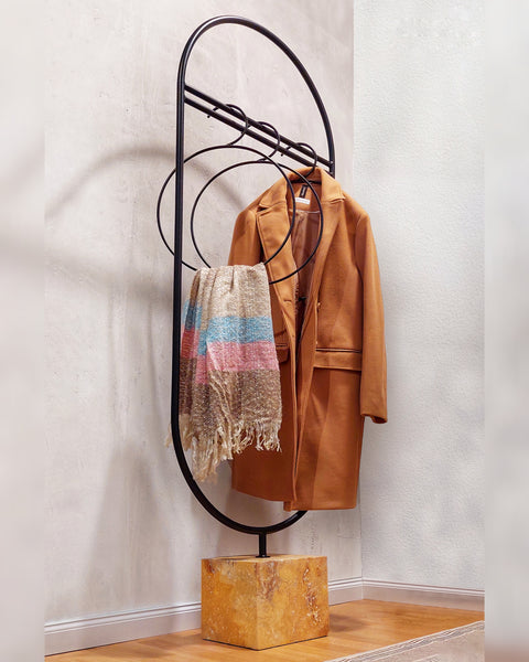 A functional piece of art, this handcrafted coat stand blends utility with sculpture. Crafted from metal with an artist's touch, its fluid form provides a sturdy and stylish place to hang your garments. A minimalist design with maximum impact, this coat stand adds an air of sophistication to your entryway or bedroom while showcasing the timeless allure of metal craftsmanship.