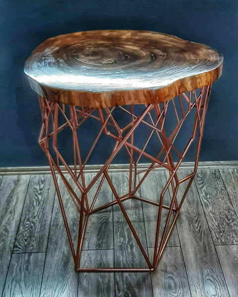Discover the allure of blended materials in this meticulously handcrafted table. Its standout feature is the intricate webbed base, a testament to the artisanal skill in metalwork. The design is both structural and decorative, offering stability and style. Topped with a round slab of polished wood, this piece serves as a stunning embodiment of craftsmanship, perfect for adding a sculptural element to your living space as a side or accent table.