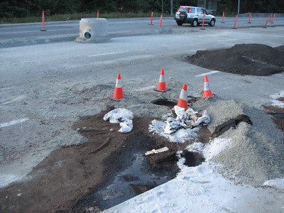 An oil spill on a public road where a contractor didn't meet OSHA spill kit requirements.