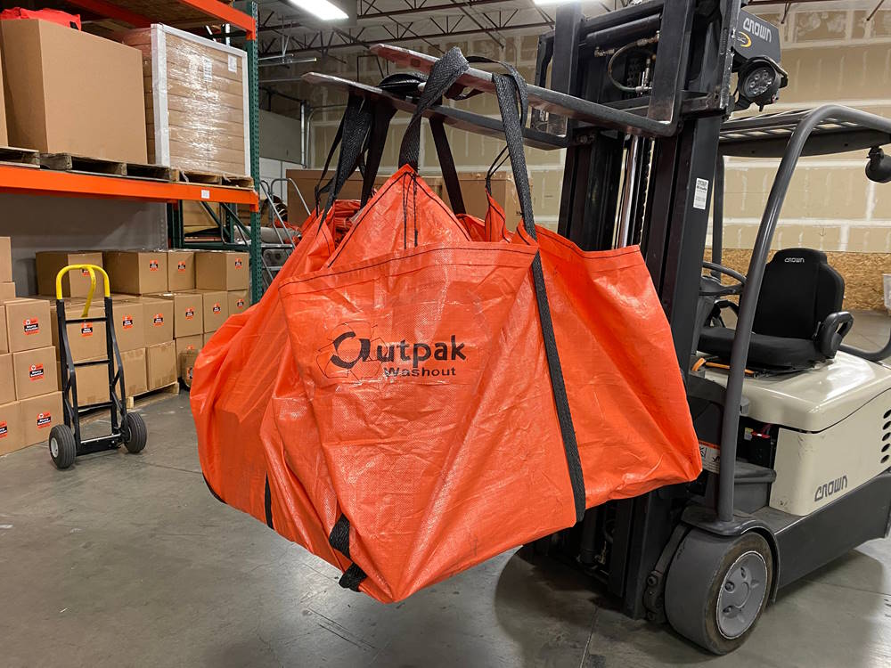 Outpak Heavy Duty Sling Tarp being used in a warehouse.