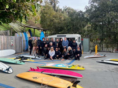 Women gathering with surfboards