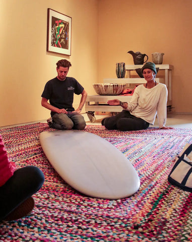 Kassia Meador and Dane Peterson with the Aqueous surf board