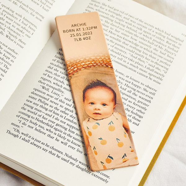 A leather bookmark printed with a photograph of a baby and a personalised message
