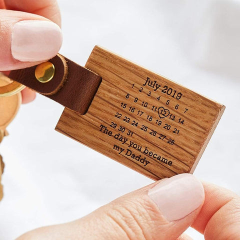 A wooden keyring engraved with a calendar design and personalised message, handmade by Create Gift Love