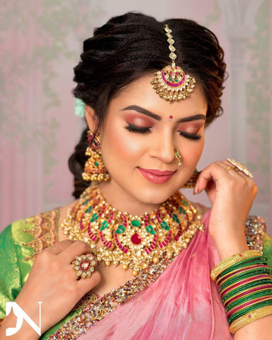 Nykaa - A beautiful doe-eyed Bengali bride with the snowy topor on her  head. Gold jewelry—the nath, (nose ring), paati haar (broad, flat necklace)  , taaira (a combinmation of a tiara and