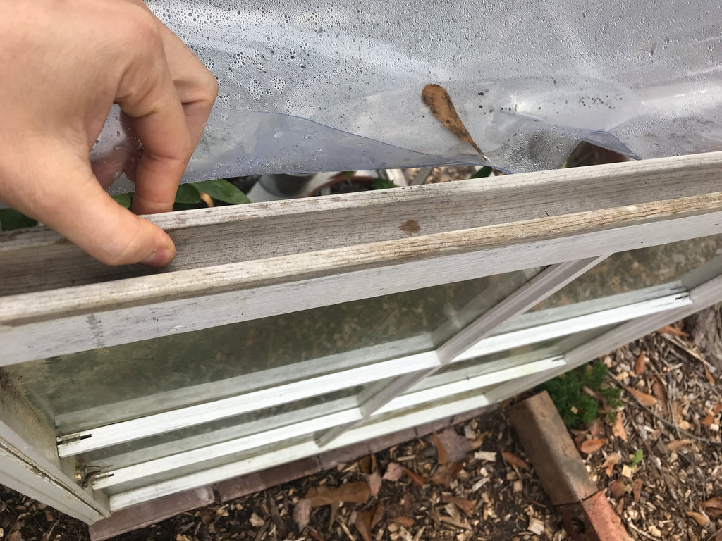 A close up image of the groove on the top portion of the door to the greenhouse