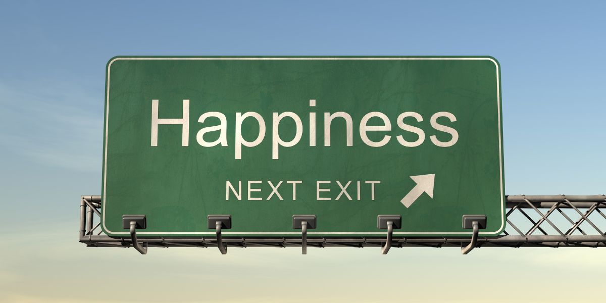 a highway exit sign that says "Happiness next exit"