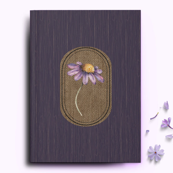 A purple journal with a wildflower flower on the front