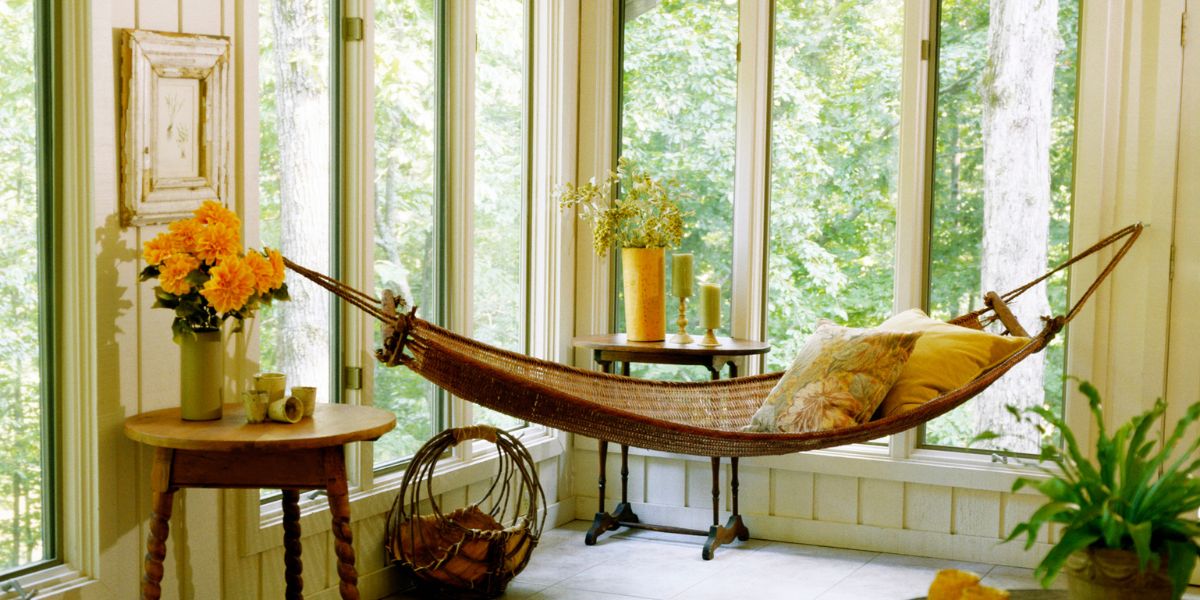 an indoor hammock hung near a window