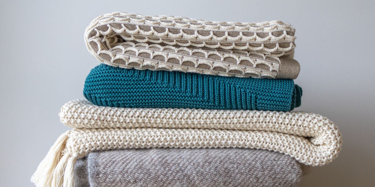 a stack of winter throws