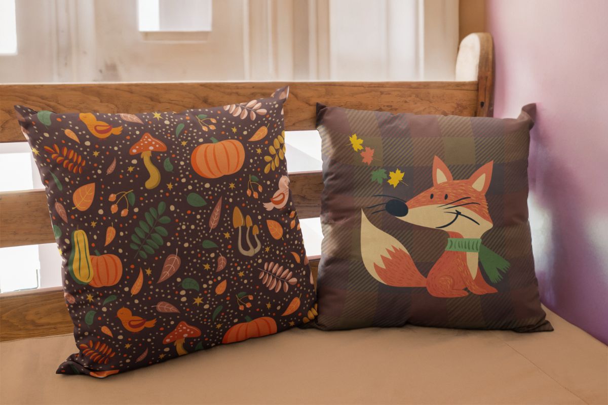 throw pillow with a whimsical fall pattern and throw pillow with an autumn fox on plaid