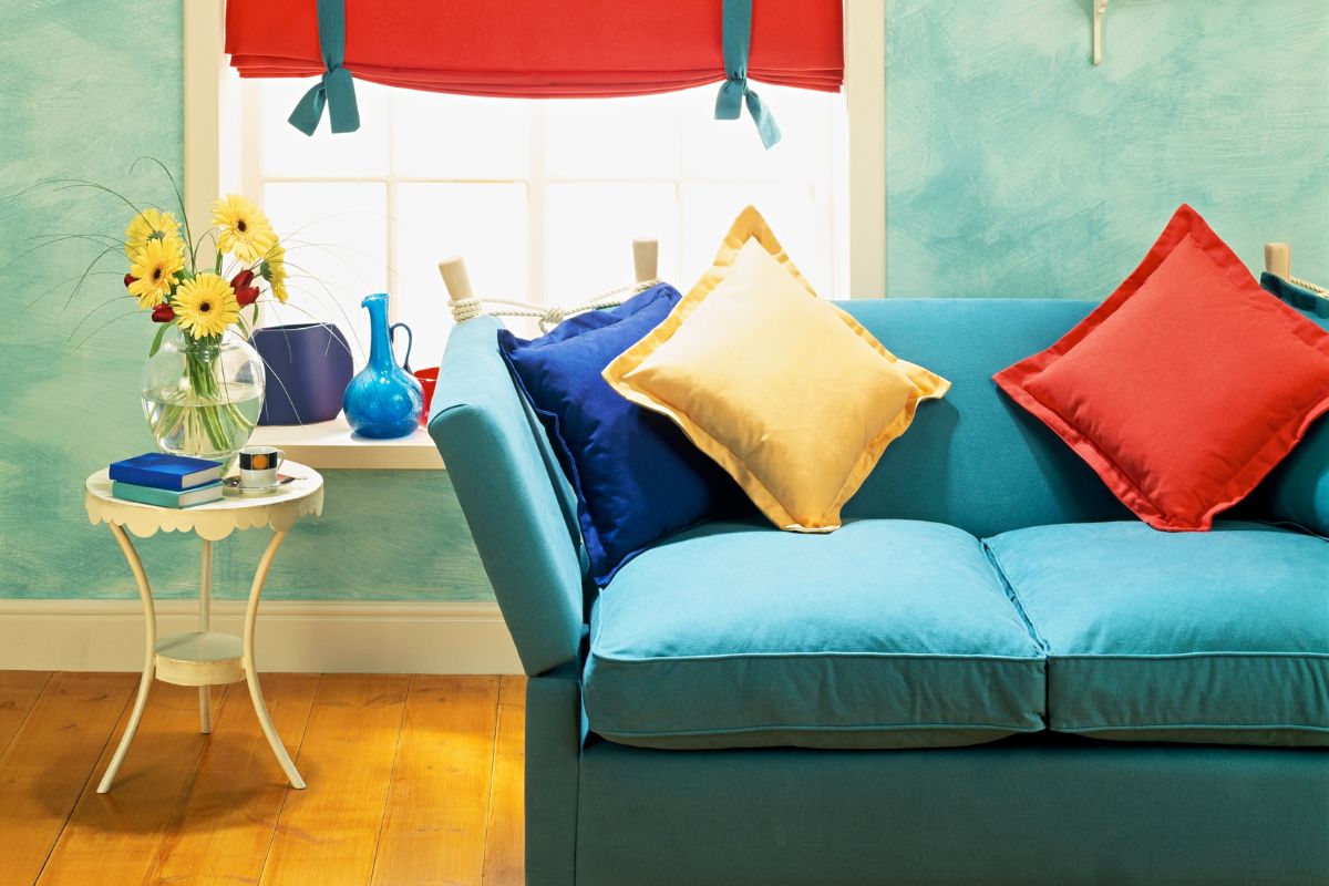 green couch with yellow and red throw pillows