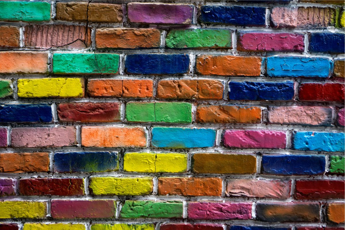 brick wall with the bricks painted different bright colors
