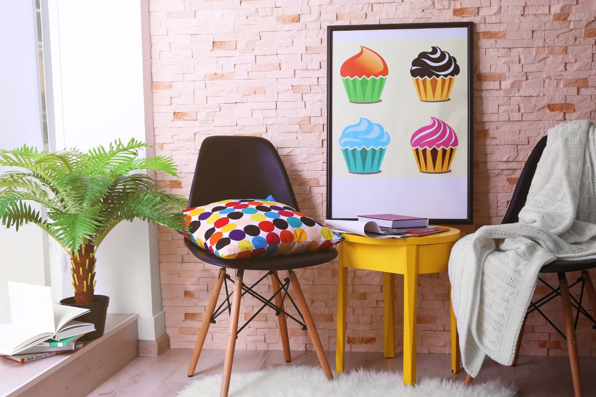 Two chairs next to a poster with cupcakes on it