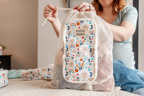 image shows a young woman using the laundry bag to store dirty washing