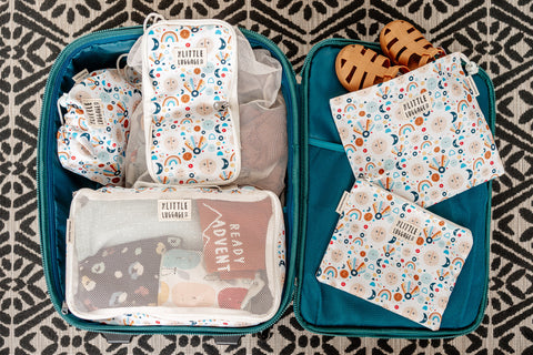 image shows little luggage co suitcase packed with packing cubes and loose items