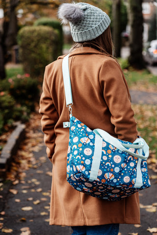 image shows young woman wearing the little luggage co tote bag over her shoulder