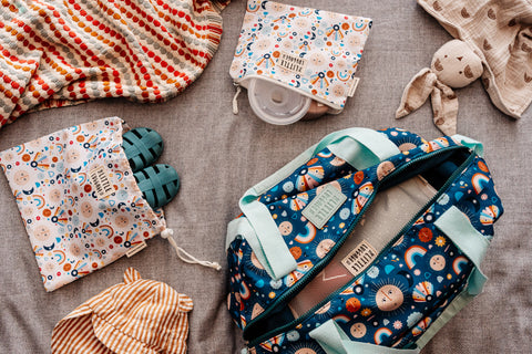 image shows the little luggage tote bag packed with baby essentials