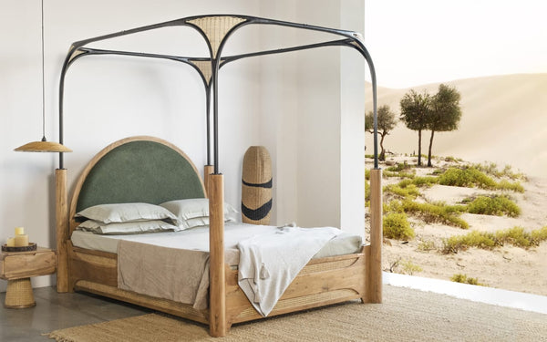 Modern canopy bed with wooden frame and contrasting metal details, featuring sustainable design elements for 2024.
