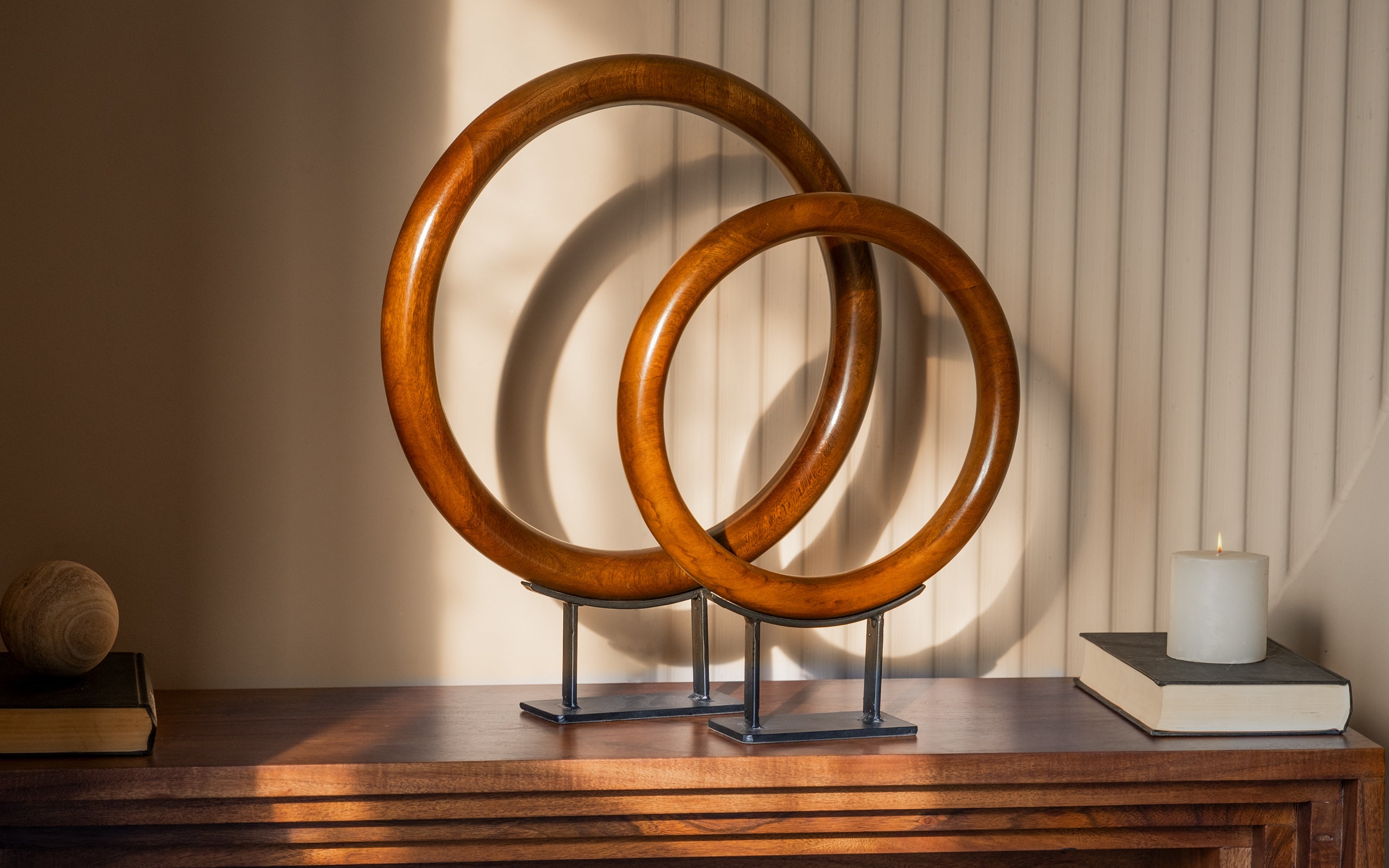 Elegant wooden crafts home decor, featuring concentric circular wooden sculptures on a modern desk.