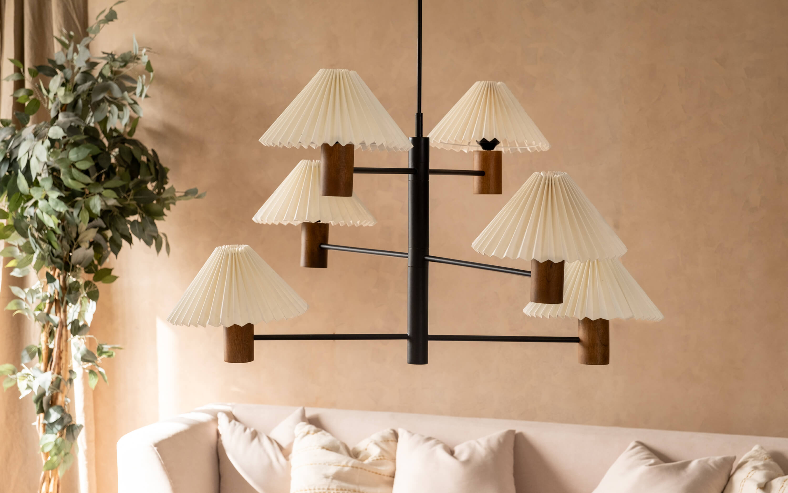 A chandelier with pleated shades and wooden details, exemplifying a mix of classic and modern styles for living room ambiance
