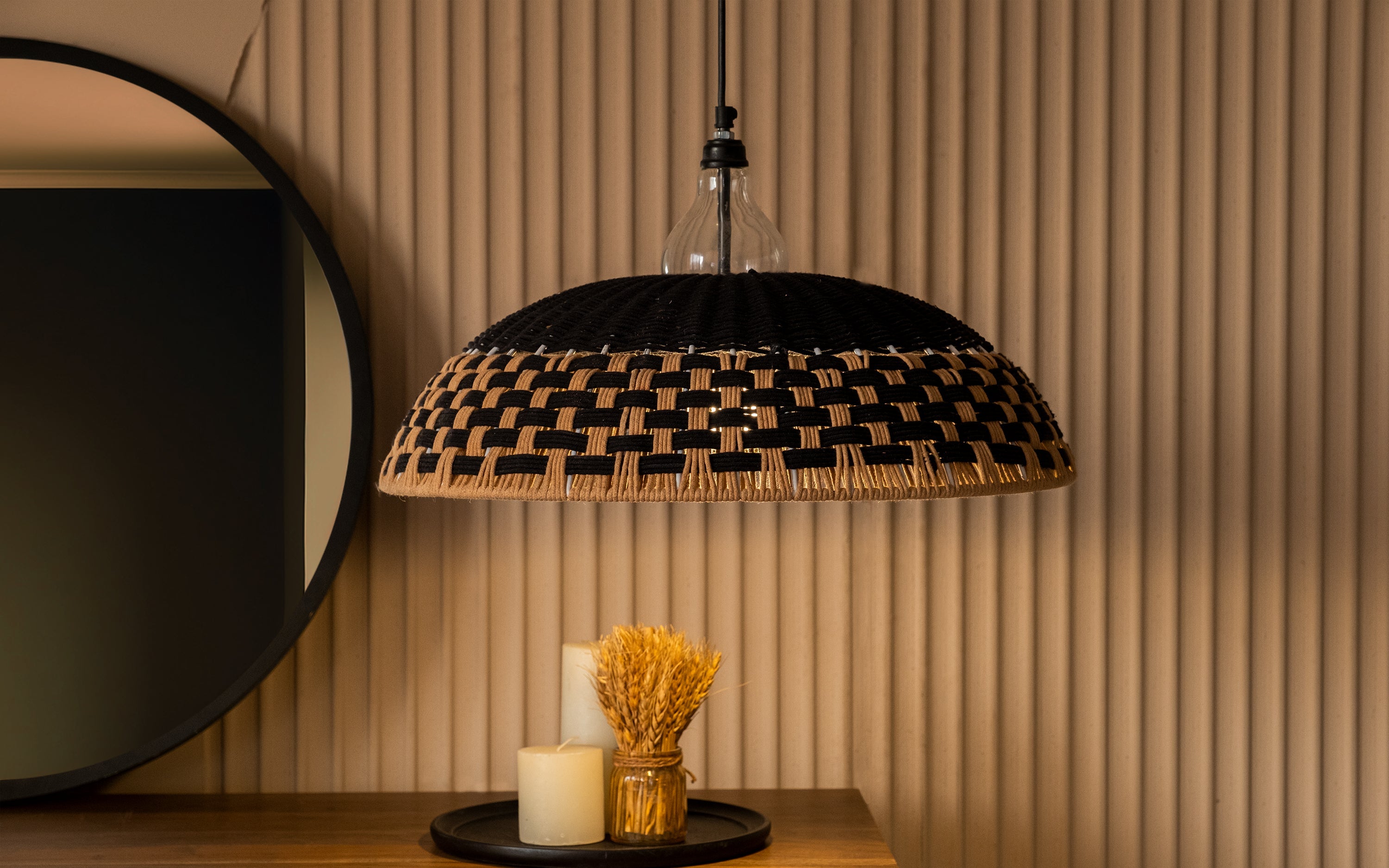 Woven rattan ceiling lamp above a cozy living room corner, enhancing the space with a warm, natural light