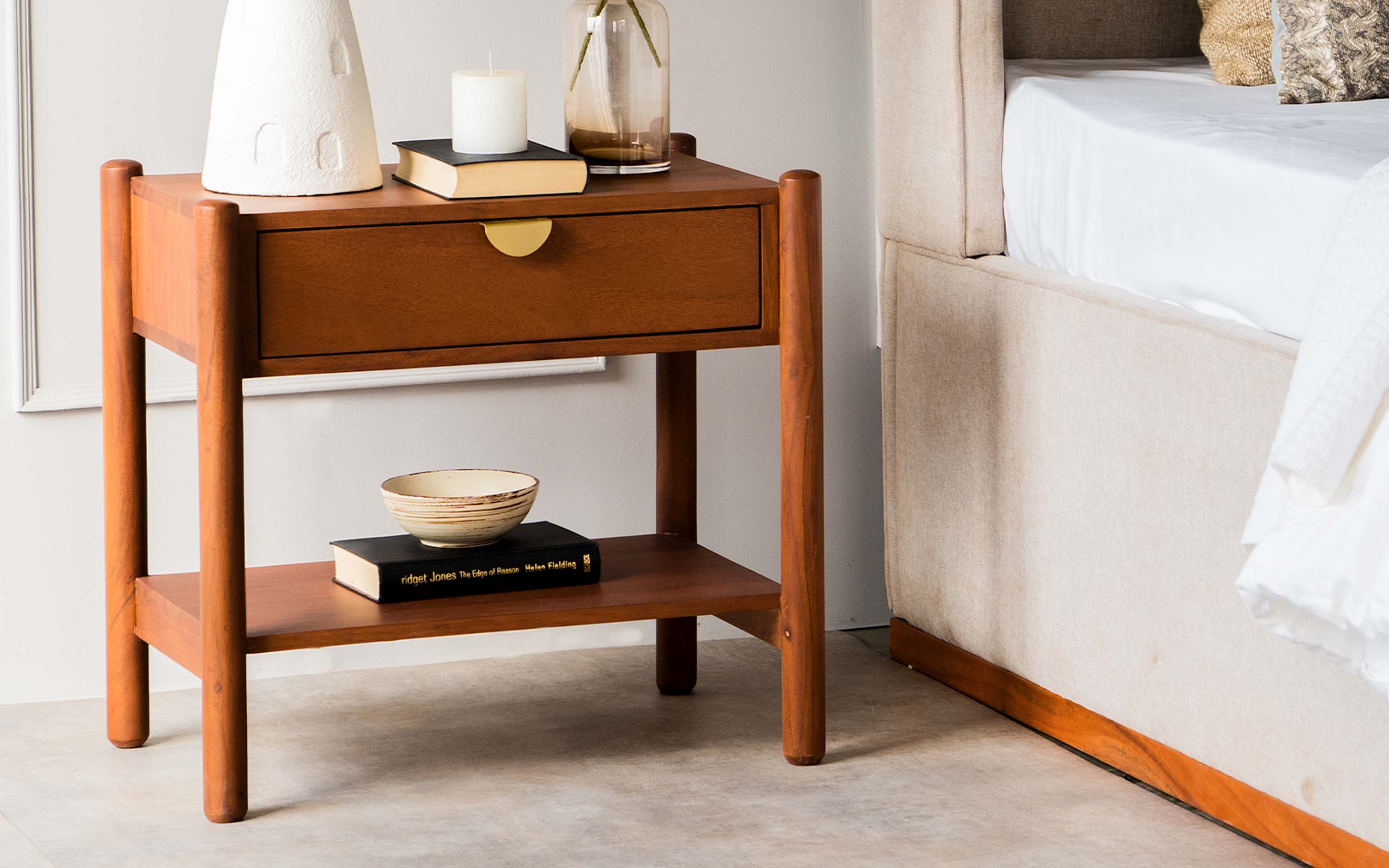 Sleek wooden bedside table with stylish decor in a contemporary luxury bedroom