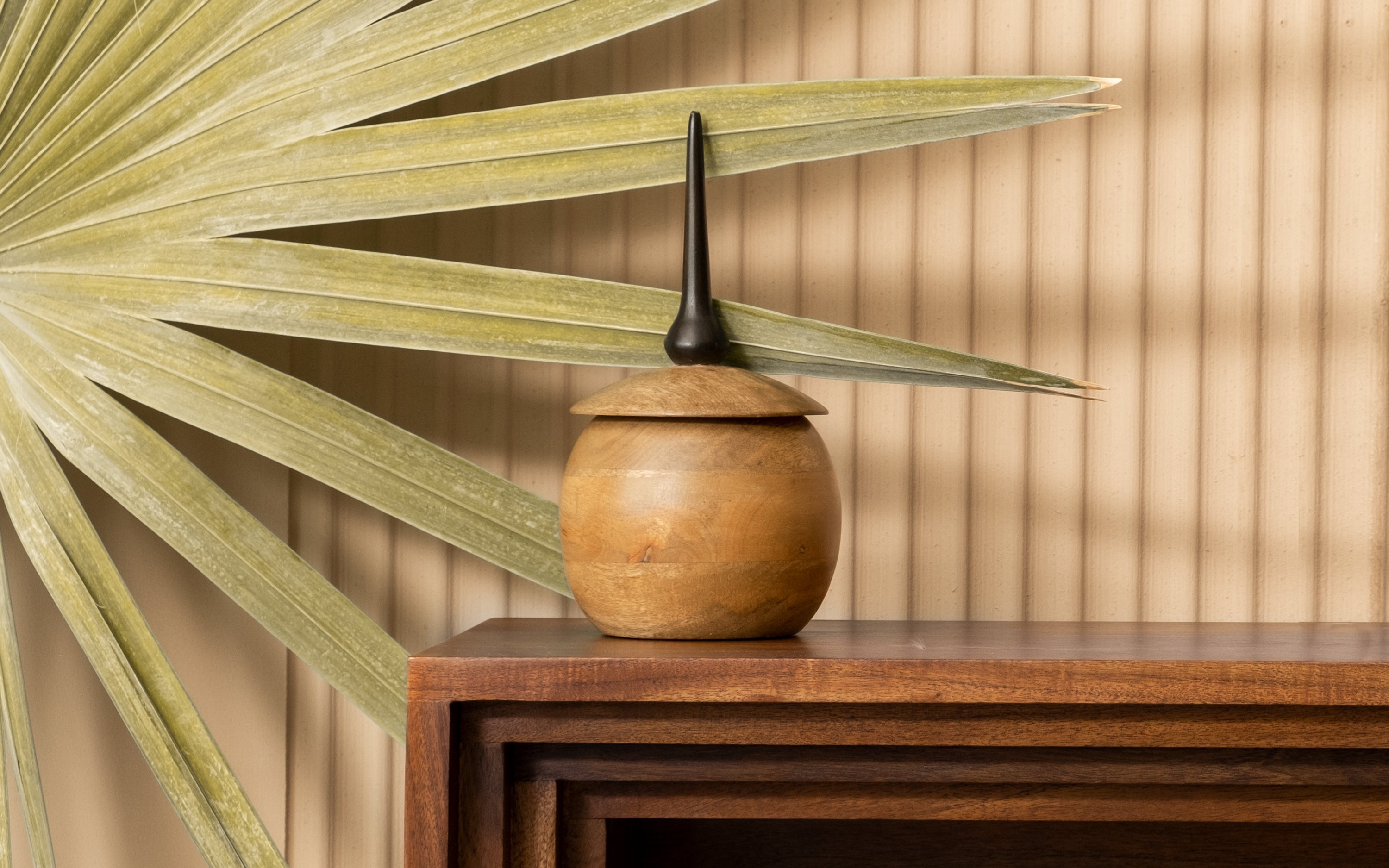 Round wooden storage box on a wooden table, a practical addition to home decor wooden items.