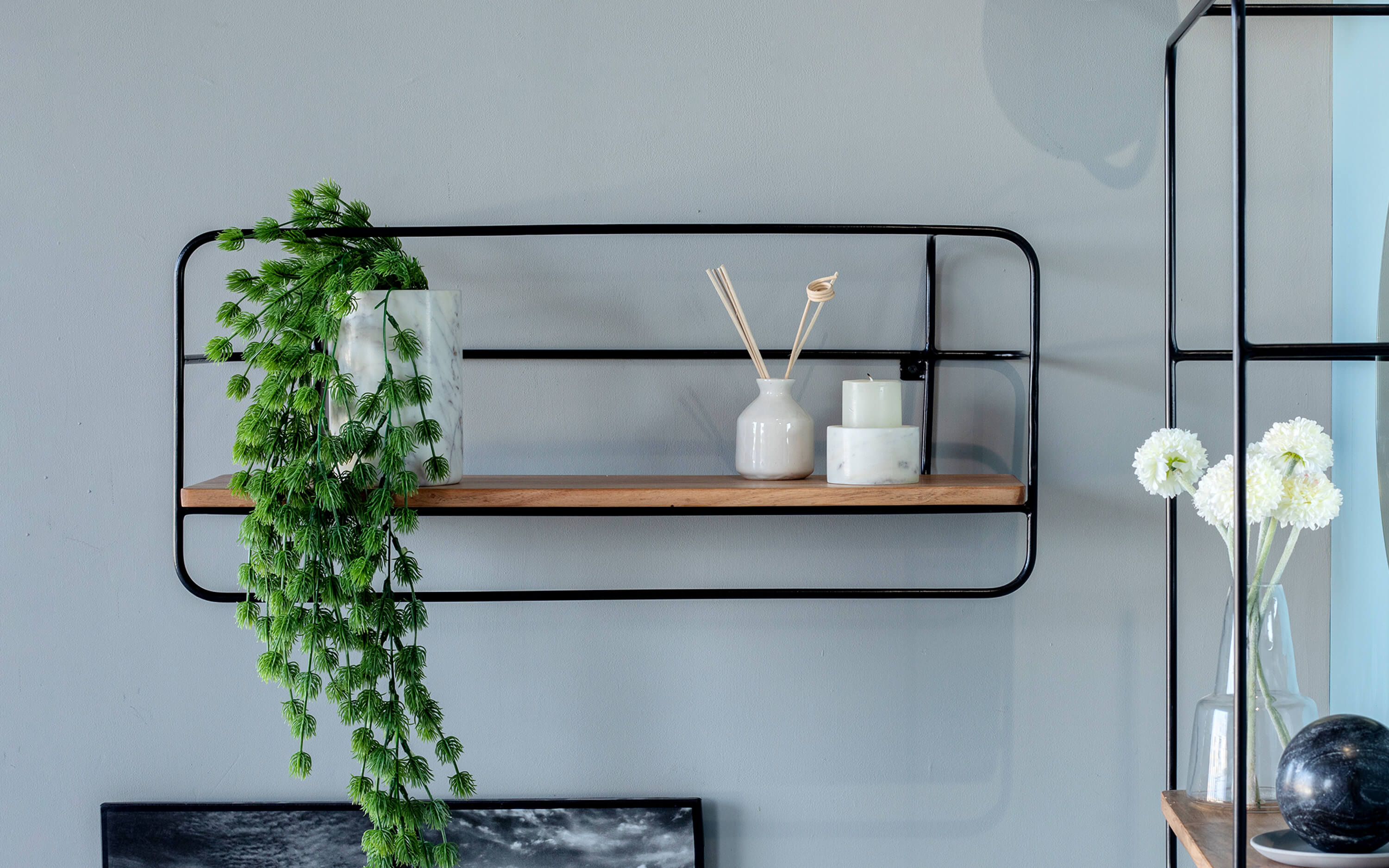 Minimalist Wall Shelf with Black Accents and planter