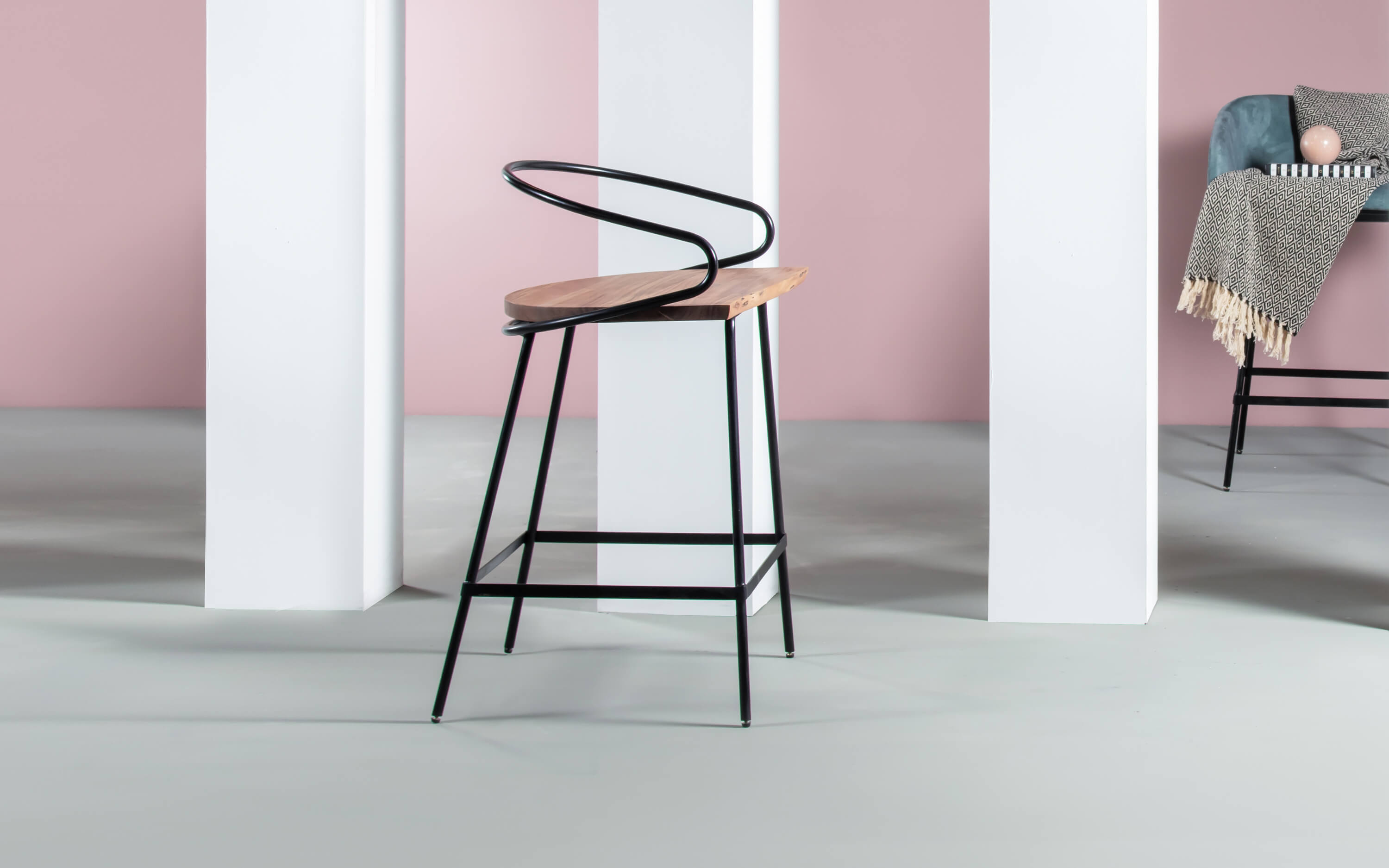 A stylish wooden bar chair with a high back and metal frame, suitable for contemporary home bar environments