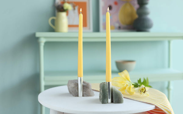 Minimalistic grey candle stand showcasing raw texture, a simple and elegant housewarming gift option for ambient lighting