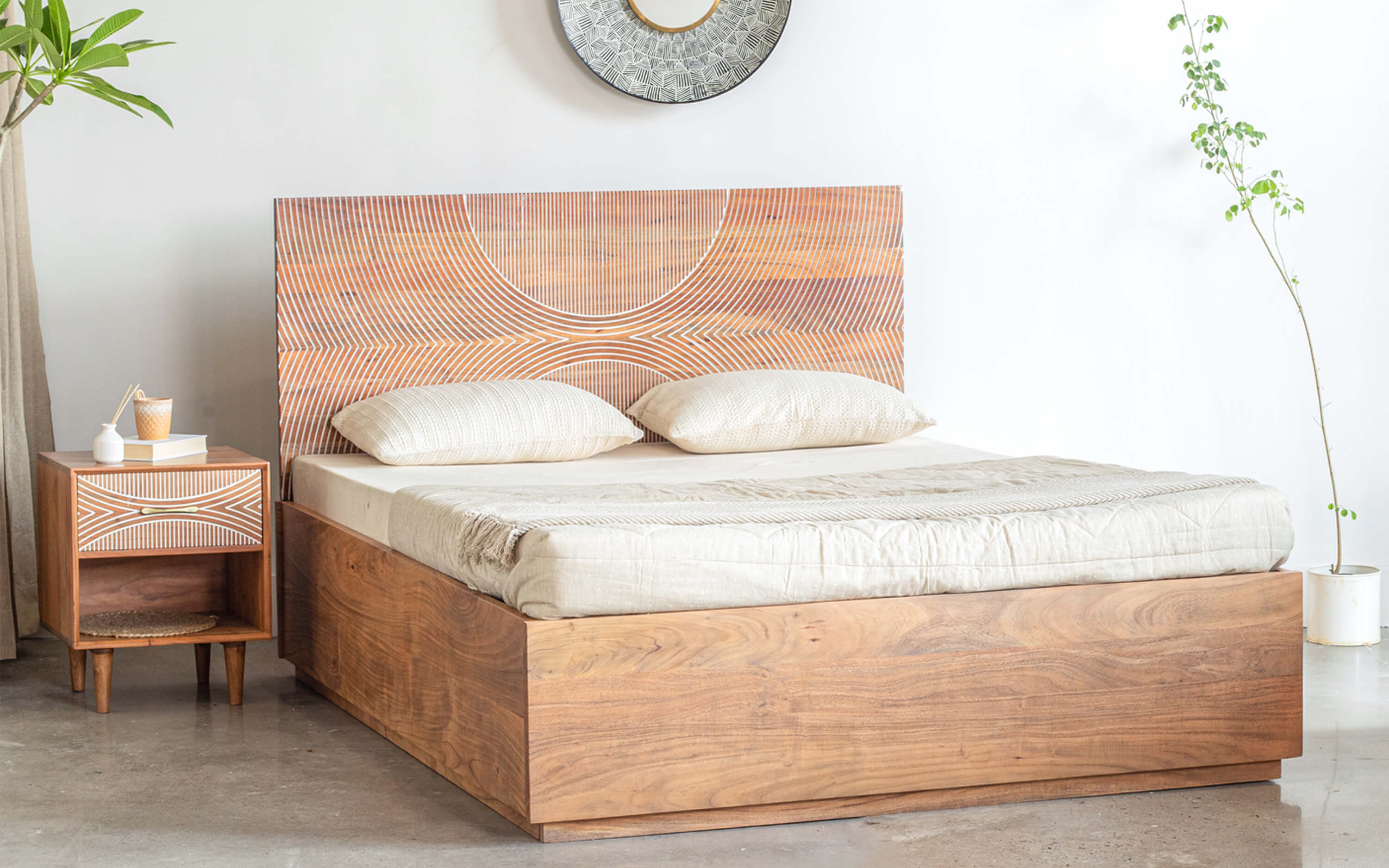 Intricate laser-cut wooden headboard with a repeating pattern, combining modern technology with traditional wood for a textured look.