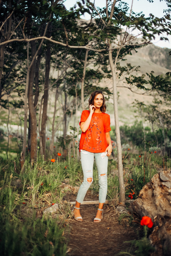 piper & scoot model wearing an orange tunic out in poppy fields