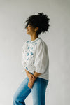 The Petersburg Embroidered Blouse in White + Blue, studio shot; front view