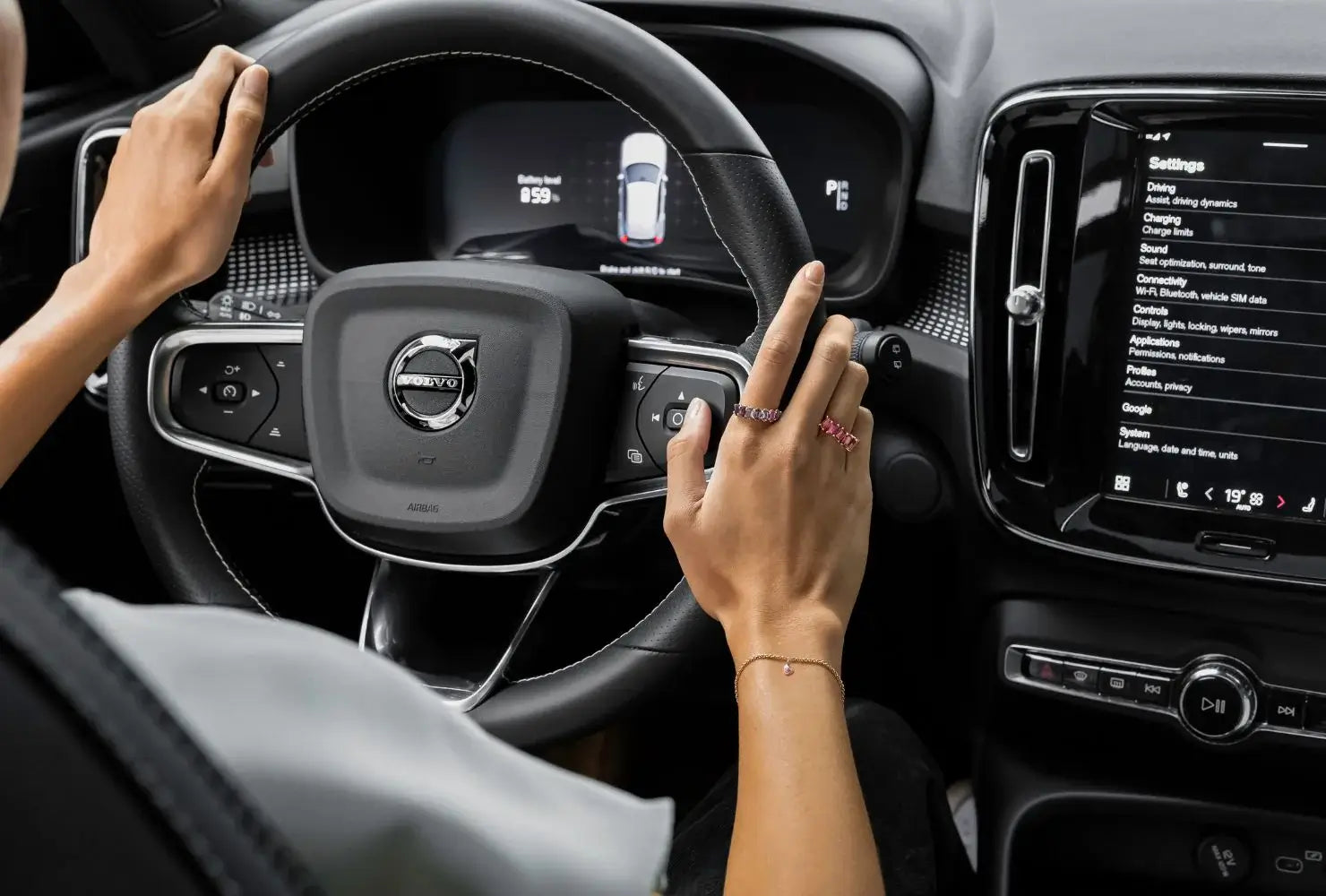A shot of the inside of a Volvo car where a model is driving whilst wearing a selection of Ecksand rings.