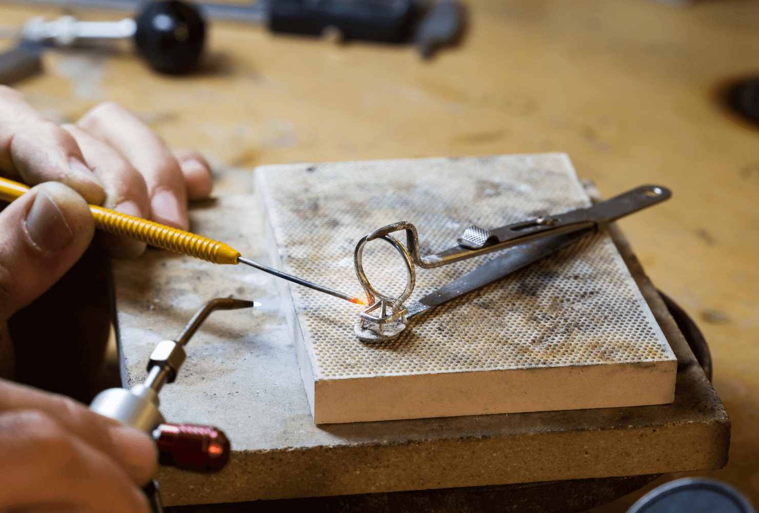 Ecksand jeweler soldering an engagement ring