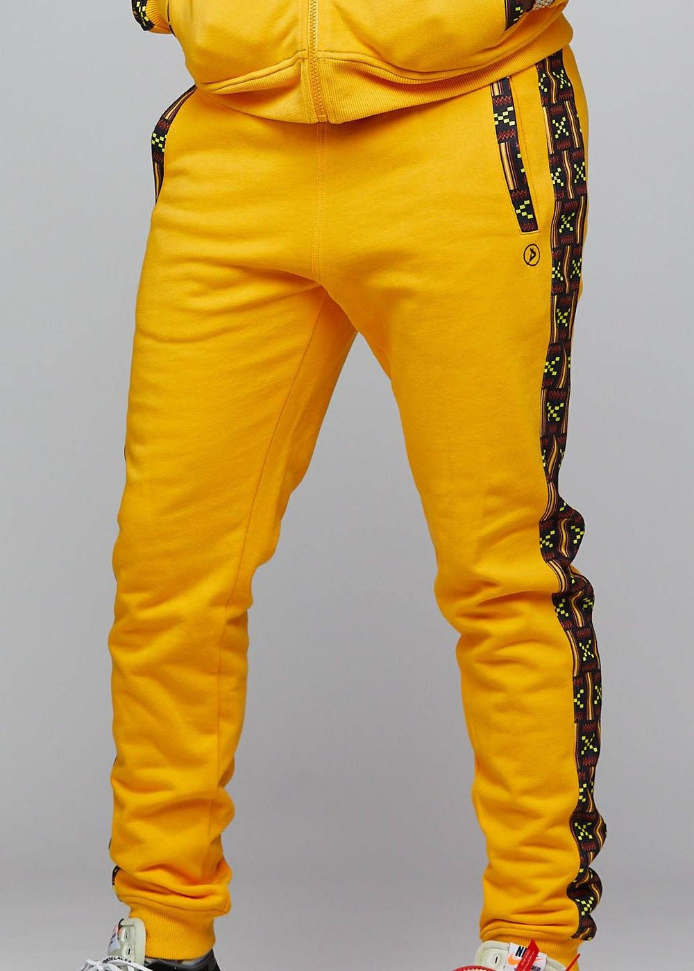 yellow joggers with black stripe